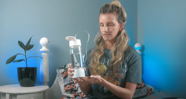 blonde female using ionbottles pro hydrogen water bottle inhaler